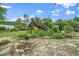 Landscaped backyard with lush greenery, garden beds, stone patio and a fire pit for outdoor enjoyment at 7805 Tuscan Ridge Dr, Wendell, NC 27591