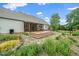 Large backyard with tiered stone landscaping, green lawn, and an inviting screened porch at 7805 Tuscan Ridge Dr, Wendell, NC 27591