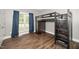 Bedroom with hardwood floors, modern furniture, and ample natural light at 7805 Tuscan Ridge Dr, Wendell, NC 27591