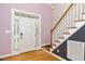 Bright foyer showcasing hardwood floors, natural lighting, and staircase at 7805 Tuscan Ridge Dr, Wendell, NC 27591