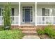 Welcoming front entrance with sidelights, steps, and classic blue door at 7805 Tuscan Ridge Dr, Wendell, NC 27591