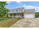 Charming home featuring a spacious front porch, attached two-car garage, and well-manicured lawn at 7805 Tuscan Ridge Dr, Wendell, NC 27591