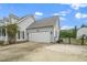 Attached two-car garage and extra parking space on the side of the driveway at 7805 Tuscan Ridge Dr, Wendell, NC 27591