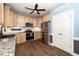 Modern kitchen with light wood cabinets, granite countertops, and stainless steel appliances at 7805 Tuscan Ridge Dr, Wendell, NC 27591