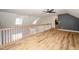 Bright living area with wood-look floors, accent wall, and staircase with white railing at 7805 Tuscan Ridge Dr, Wendell, NC 27591