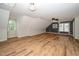 Open living area with wood-look flooring, recessed lighting, and large windows at 7805 Tuscan Ridge Dr, Wendell, NC 27591