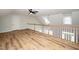 Spacious living area with wood-look flooring, white railing and abundant natural light at 7805 Tuscan Ridge Dr, Wendell, NC 27591