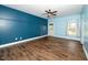 Spacious living room with hardwood floors, ceiling fan and bright windows to allow for natural light at 7805 Tuscan Ridge Dr, Wendell, NC 27591