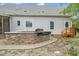 Outdoor kitchen featuring a stone surround, built in grill, stone patio and outdoor string lights at 7805 Tuscan Ridge Dr, Wendell, NC 27591