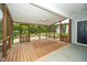 Inviting screened porch with wood flooring and ceiling fan overlooking landscaped yard at 7805 Tuscan Ridge Dr, Wendell, NC 27591