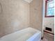 Bathroom featuring a white bathtub and classic tile at 80 Dunn Rd, Louisburg, NC 27549