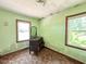 Bedroom with vintage dresser and natural light from two windows at 80 Dunn Rd, Louisburg, NC 27549