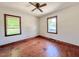 Bedroom with hardwood floors, a ceiling fan, and two windows at 80 Dunn Rd, Louisburg, NC 27549