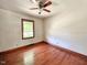 Bedroom featuring hardwood floors, a window, and a ceiling fan at 80 Dunn Rd, Louisburg, NC 27549