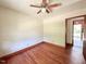 Bedroom featuring hardwood floors, a closet, doorway, and ceiling fan at 80 Dunn Rd, Louisburg, NC 27549