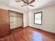 Bedroom featuring hardwood floors, a window, a closet, and a ceiling fan at 80 Dunn Rd, Louisburg, NC 27549