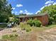 Side view of a single-story brick home with a small porch at 80 Dunn Rd, Louisburg, NC 27549