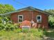 Close up of a single-story brick home featuring two windows and side entrance at 80 Dunn Rd, Louisburg, NC 27549