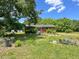 A view of the rear of a single-story brick home surrounded by trees at 80 Dunn Rd, Louisburg, NC 27549