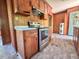 Functional kitchen featuring wood cabinetry, laminate counters, and a stainless steel range at 80 Dunn Rd, Louisburg, NC 27549