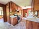 Functional kitchen featuring an electric range, wood cabinetry, and laminate counters at 80 Dunn Rd, Louisburg, NC 27549
