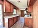 Traditional kitchen with wood cabinets, laminate countertops, and a window over the sink at 80 Dunn Rd, Louisburg, NC 27549