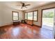 Bright living room with a ceiling fan, hardwood floors, and natural light at 80 Dunn Rd, Louisburg, NC 27549