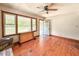 Sunlit living room featuring wood floors, a ceiling fan, and a doorway to the exterior at 80 Dunn Rd, Louisburg, NC 27549