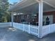 This brick home features an attached covered area with white picket fencing at 8019 W Tarboro Rd, Rocky Mount, NC 27803