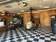 Organized garage with checkered floors, overhead lighting, and ample storage space at 8019 W Tarboro Rd, Rocky Mount, NC 27803
