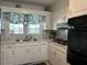 Bright kitchen featuring white cabinets and modern appliances at 8019 W Tarboro Rd, Rocky Mount, NC 27803