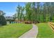 Spacious backyard with in-ground pool, grassy lawn, mature trees and landscaping at 808 Wimberly Rd, Apex, NC 27523