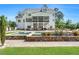 Beautiful backyard features a stone-accented pool with a spa, lush landscaping, and a spacious covered porch at 808 Wimberly Rd, Apex, NC 27523