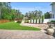 Manicured backyard features lush green grass and tiered garden beds with white stone and black fencing at 808 Wimberly Rd, Apex, NC 27523