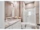 Modern bathroom with granite countertop, frameless shower, and neutral colors at 808 Wimberly Rd, Apex, NC 27523
