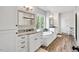 Elegant bathroom with double vanity, soaking tub, wood-look tile floors and plenty of natural light at 808 Wimberly Rd, Apex, NC 27523