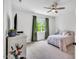 Comfortable bedroom featuring plush carpeting, a ceiling fan, and natural light at 808 Wimberly Rd, Apex, NC 27523