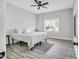 Bedroom with neutral walls, light wood floors, ceiling fan, and a large window at 808 Wimberly Rd, Apex, NC 27523