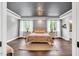Comfortable bedroom featuring a decorative ceiling, hardwood floors, and neutral colors that create a relaxing atmosphere at 808 Wimberly Rd, Apex, NC 27523