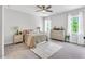 Bright bedroom featuring neutral walls, carpet, ceiling fan and natural light from two windows at 808 Wimberly Rd, Apex, NC 27523