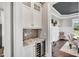 Butler's pantry featuring granite countertops, tile backsplash, wine cooler, and convenient access to the dining room at 808 Wimberly Rd, Apex, NC 27523