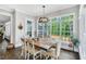Bright dining room with hardwood floors and large windows with backyard view at 808 Wimberly Rd, Apex, NC 27523