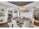Elegant dining room with dark ceiling trim, a chandelier, and views into the office and living room at 808 Wimberly Rd, Apex, NC 27523