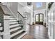 Bright foyer features hardwood floors, staircase, and paneled walls at 808 Wimberly Rd, Apex, NC 27523