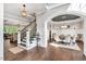 Elegant foyer with hardwood floors, staircase, and an arched entrance leading to a formal dining room at 808 Wimberly Rd, Apex, NC 27523