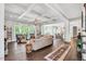 Open living room with coffered ceilings, hardwood floors, and large windows at 808 Wimberly Rd, Apex, NC 27523