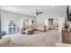 Bright living room featuring a ceiling fan, staircase, comfortable seating area, and neutral decor at 808 Wimberly Rd, Apex, NC 27523