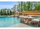 Stunning backyard pool with stone waterfalls and a spa, surrounded by lush landscaping and a wood fence at 808 Wimberly Rd, Apex, NC 27523