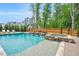 Luxury backyard pool featuring a spa, stone waterfalls, and lush landscaping, with a wood fence surrounding at 808 Wimberly Rd, Apex, NC 27523