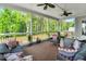 Covered porch with comfortable seating and scenic wooded view at 808 Wimberly Rd, Apex, NC 27523